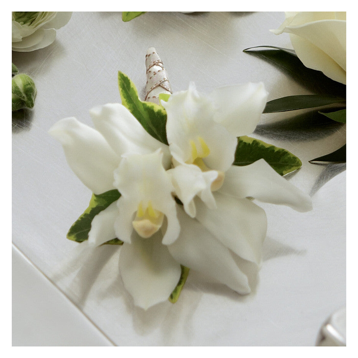 White Mini Cymbidium Boutonniere flower arrangement