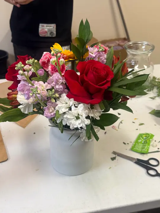 Red rose and spring flower vase made by the florist