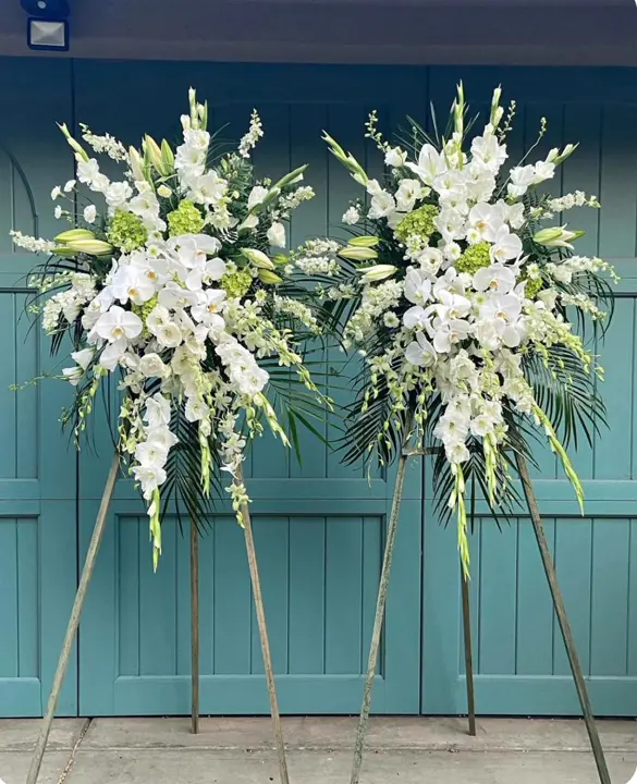 Pair of white orchid funeral standing sprays