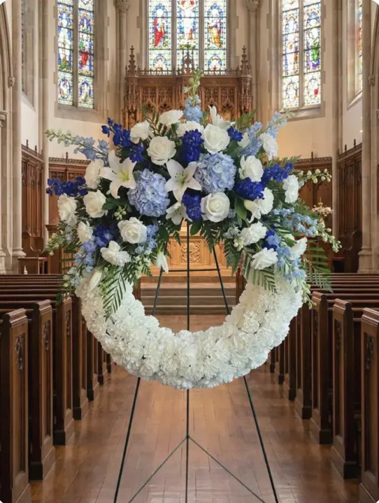 Blue and white funeral wreath inside a chapel