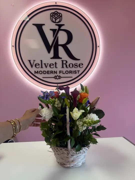 Sympathy basket arrangement under the Velvet Rose sign