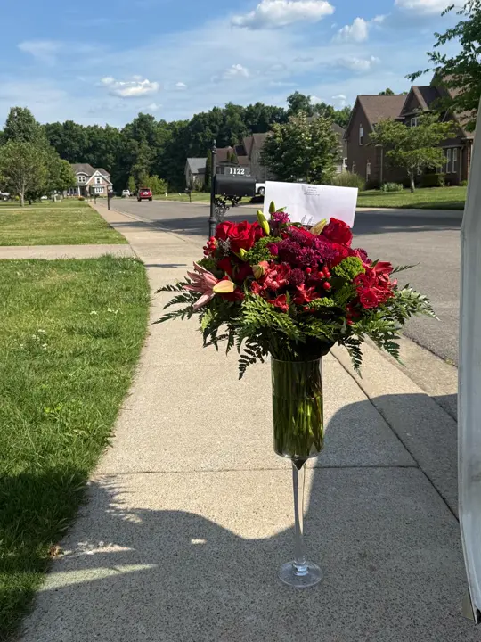 Red rose vase arrangement delivered in a neighborhood