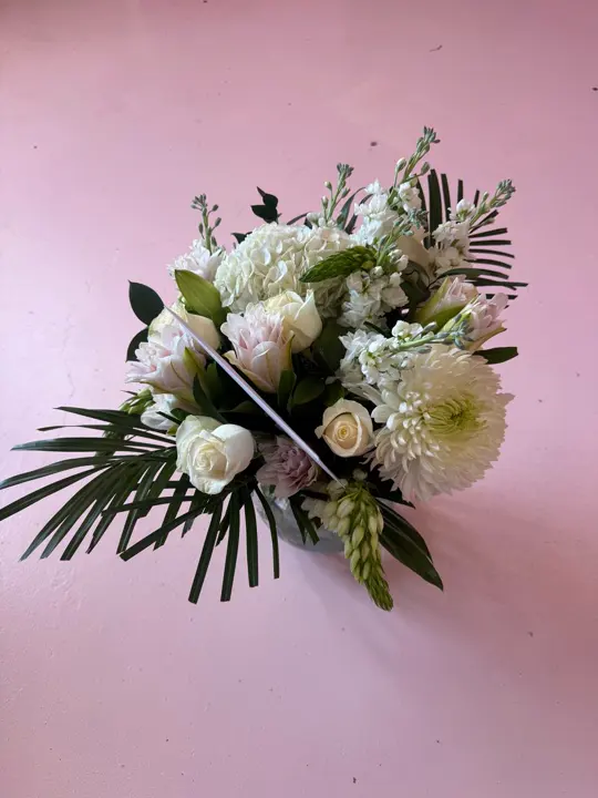 White sympathy bouquet photographed in the shop