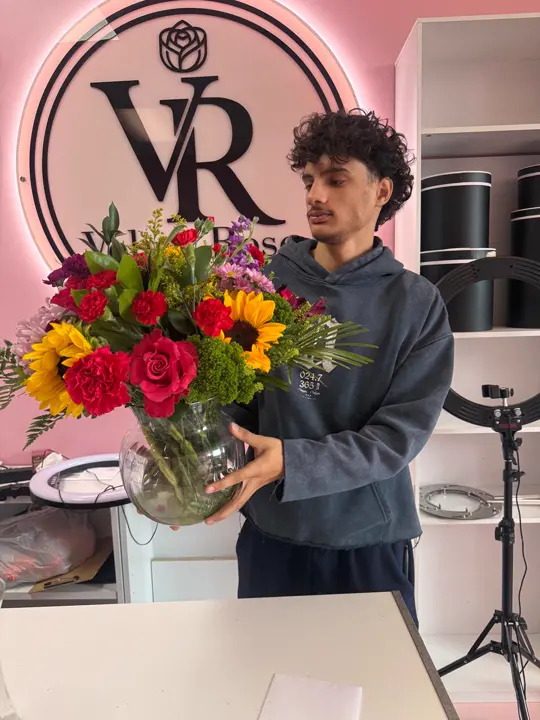 Fresh sunflower bouquet held by a Velvet Rose florist
